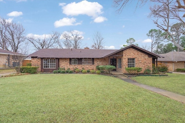 single story home featuring a front lawn