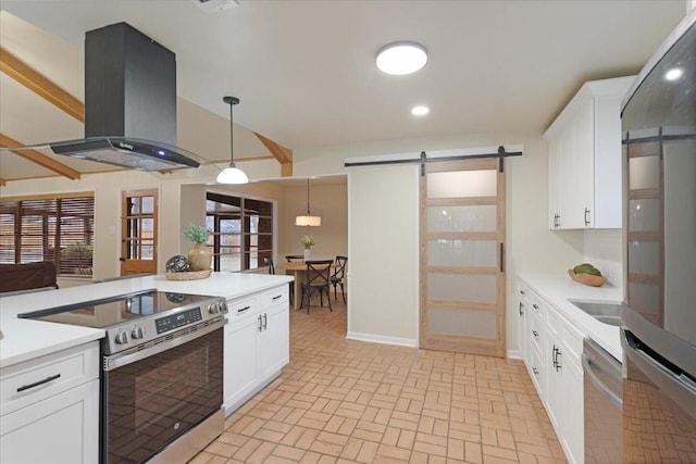 kitchen with pendant lighting, stainless steel range with electric stovetop, white cabinetry, island exhaust hood, and a barn door