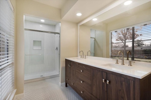 bathroom with vanity, a shower with shower door, and tile patterned flooring