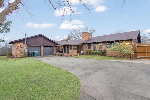 ranch-style home featuring a garage and a front yard