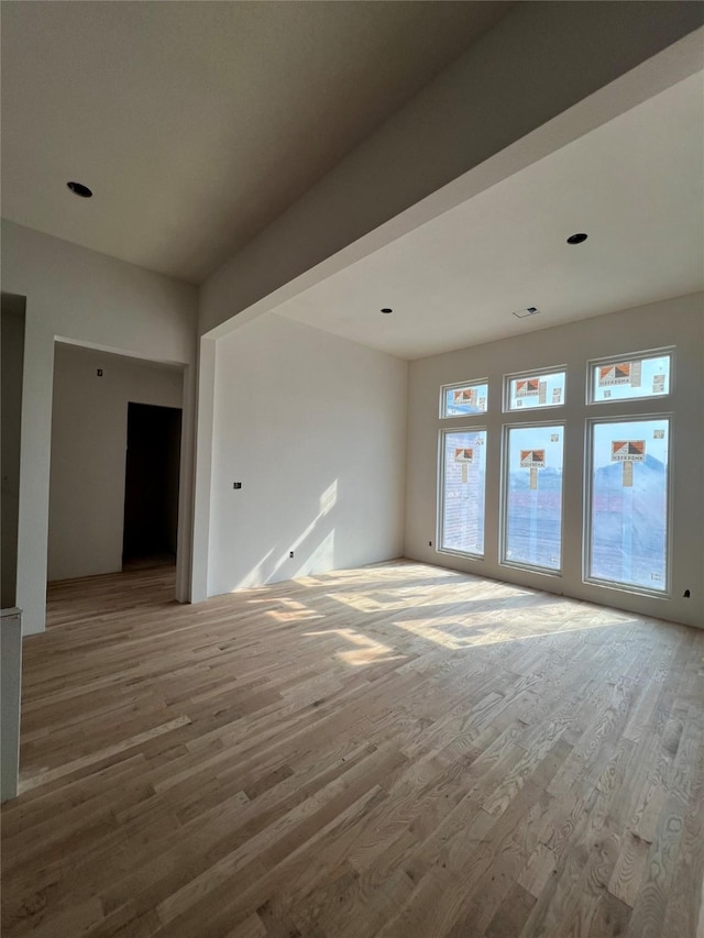 unfurnished room with wood finished floors