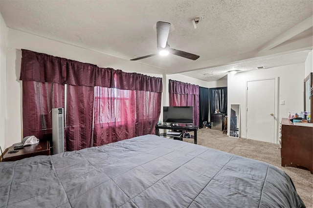 bedroom featuring carpet, a textured ceiling, and ceiling fan