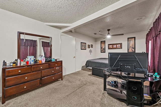 bedroom featuring light carpet, ceiling fan, and a textured ceiling