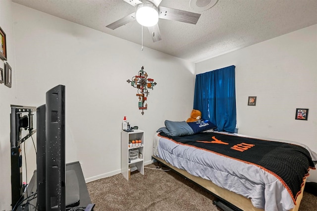 carpeted bedroom featuring ceiling fan and a textured ceiling