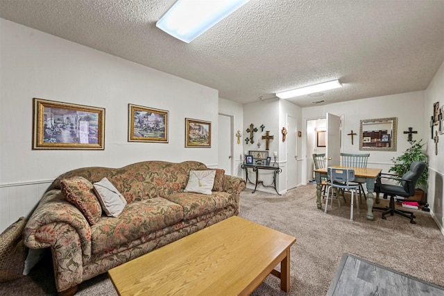 carpeted living room with a textured ceiling