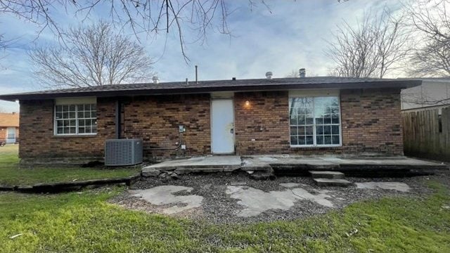 back of property with a yard, central AC unit, and a patio area