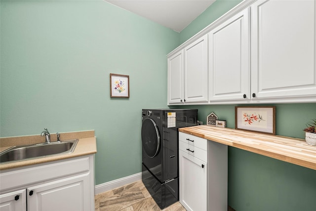 laundry room featuring cabinets, sink, and washing machine and dryer