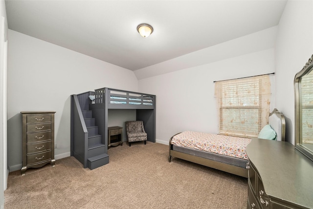 carpeted bedroom with vaulted ceiling