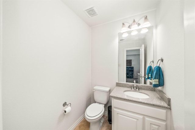 bathroom with vanity, toilet, and tile patterned flooring