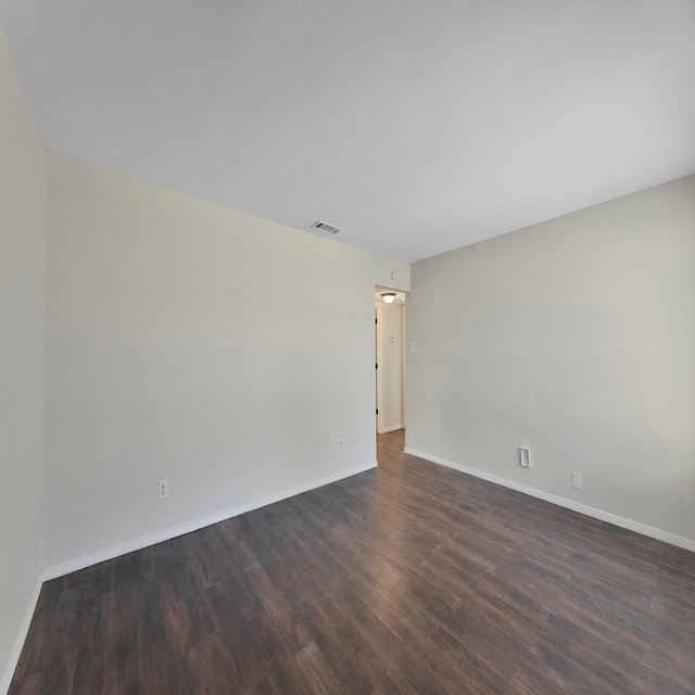 empty room featuring dark hardwood / wood-style flooring