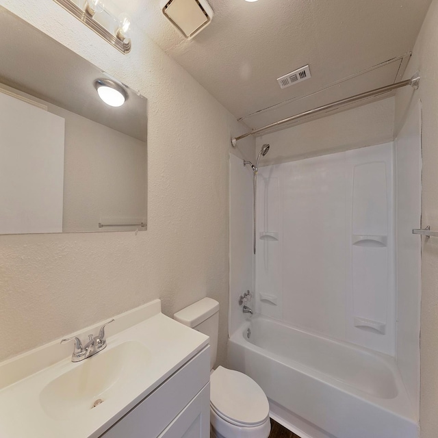 full bathroom with vanity, a textured ceiling,  shower combination, and toilet