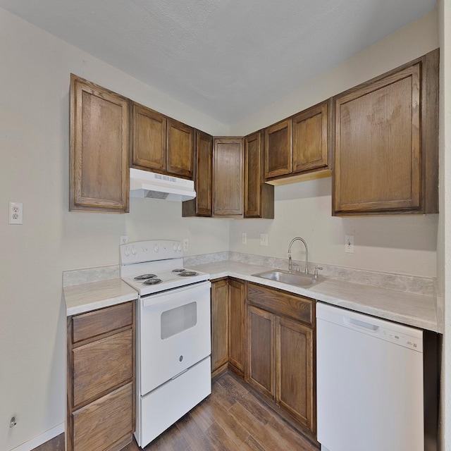 kitchen with sink, white appliances, and dark wood-type flooring