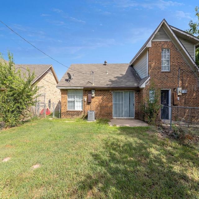 rear view of house featuring cooling unit, a yard, and a patio area