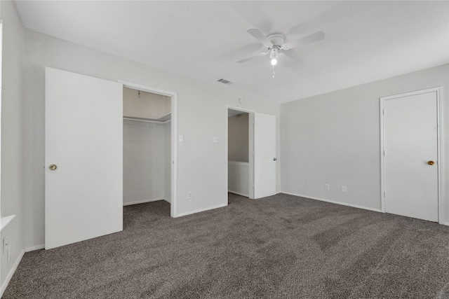 unfurnished bedroom with dark carpet and ceiling fan