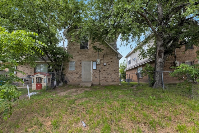 rear view of property with cooling unit