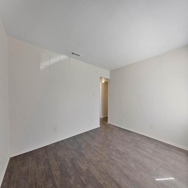 empty room featuring dark hardwood / wood-style floors