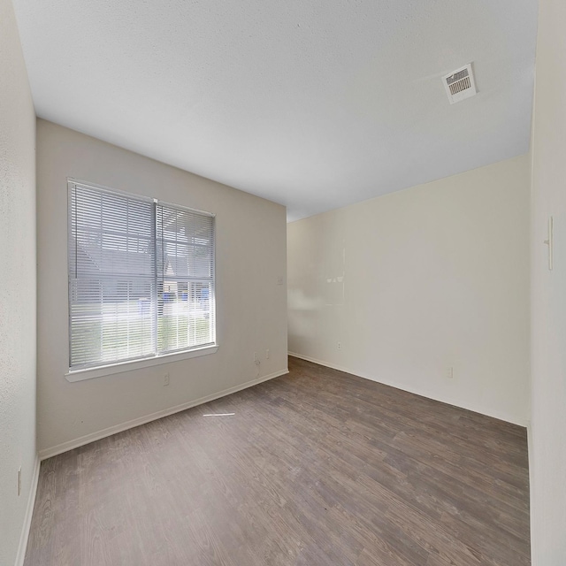 spare room featuring dark hardwood / wood-style flooring