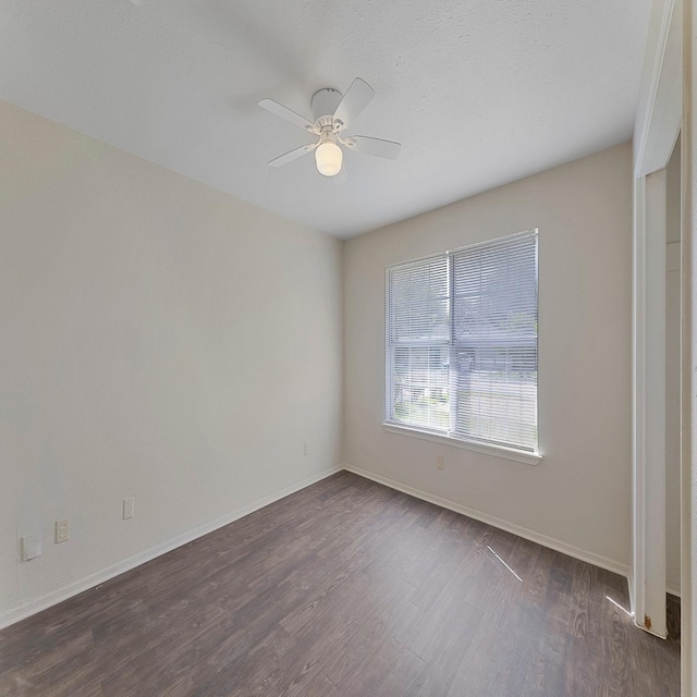 empty room featuring dark hardwood / wood-style flooring and ceiling fan