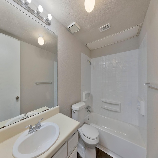 full bathroom featuring vanity, toilet, shower / bath combination, and a textured ceiling