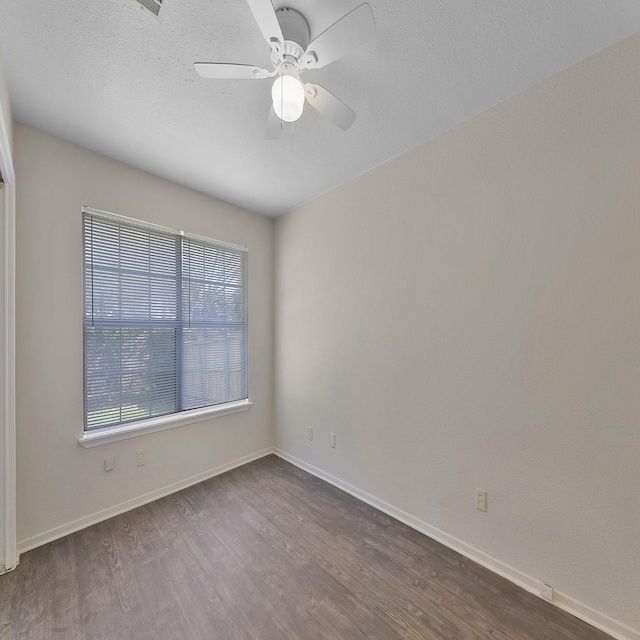 empty room featuring hardwood / wood-style flooring and ceiling fan