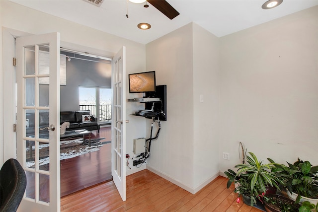 interior space featuring wood-type flooring, french doors, and ceiling fan