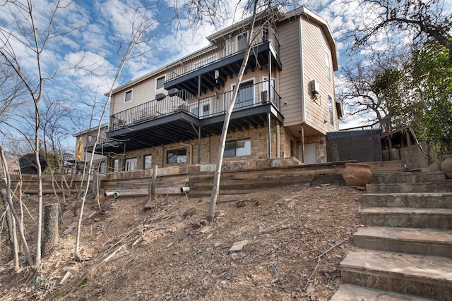 back of house featuring a balcony