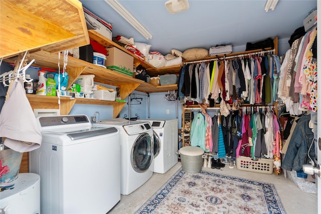 clothes washing area with washing machine and dryer