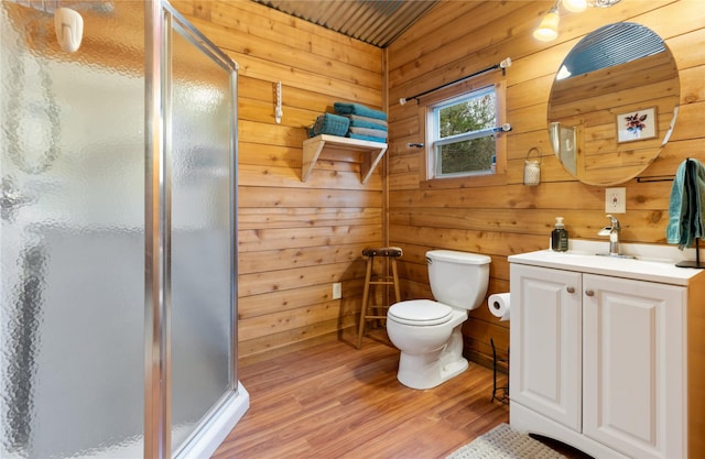 bathroom with vanity, wood-type flooring, toilet, and walk in shower