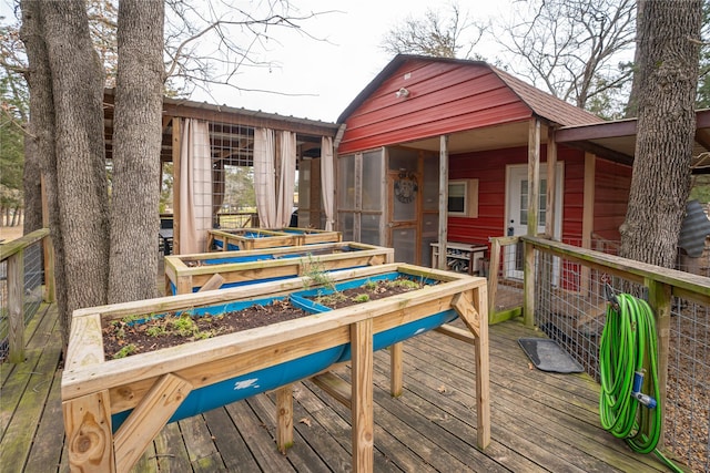 wooden deck featuring a sunroom and a jacuzzi