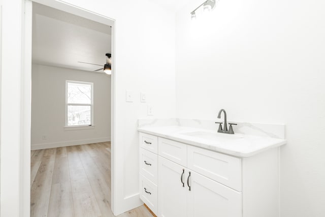 308 Santa Fe, Wolfe City, TX 75496 - bathroom with vanity, baseboards, ceiling fan, and wood finished floors