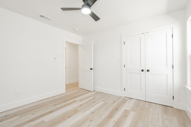 308 Santa Fe, Wolfe City, TX 75496 - unfurnished bedroom with baseboards, visible vents, a ceiling fan, a closet, and wood finished floors