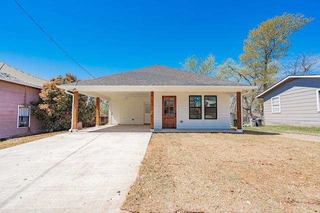 308 Santa Fe, Wolfe City, TX 75496 - view of front of house with a front yard, an attached carport, roof with shingles, driveway, and covered porch