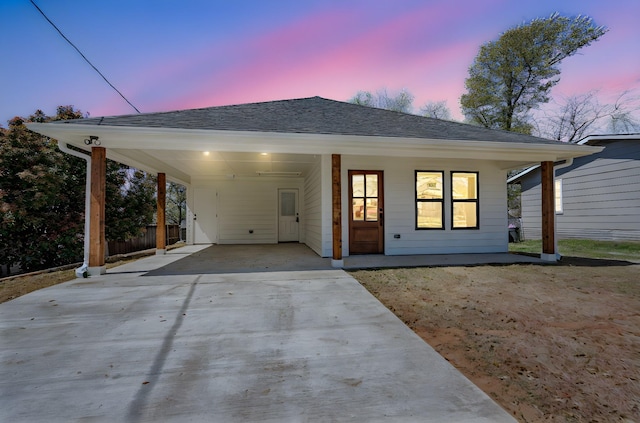 308 Santa Fe, Wolfe City, TX 75496 - view of front facade with an attached carport, concrete driveway, and roof with shingles