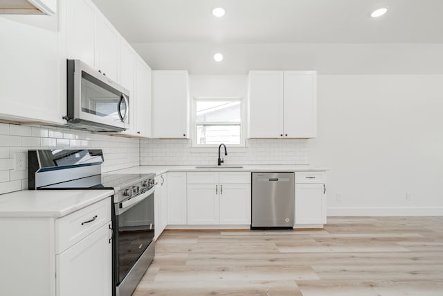 308 Santa Fe, Wolfe City, TX 75496 - kitchen featuring white cabinetry, light countertops, a sink, and stainless steel appliances