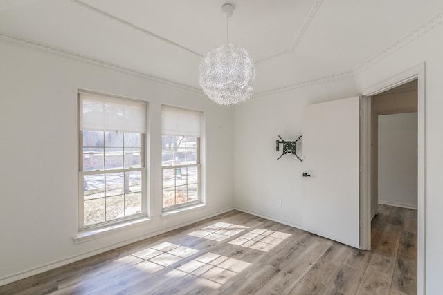 unfurnished dining area with an inviting chandelier and light hardwood / wood-style floors