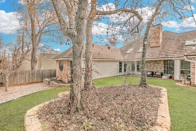 rear view of house with a yard