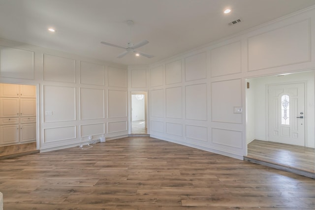 interior space featuring hardwood / wood-style flooring, ceiling fan, and crown molding