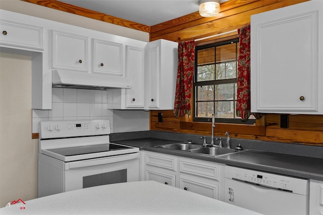 kitchen featuring sink, backsplash, white cabinets, and white appliances