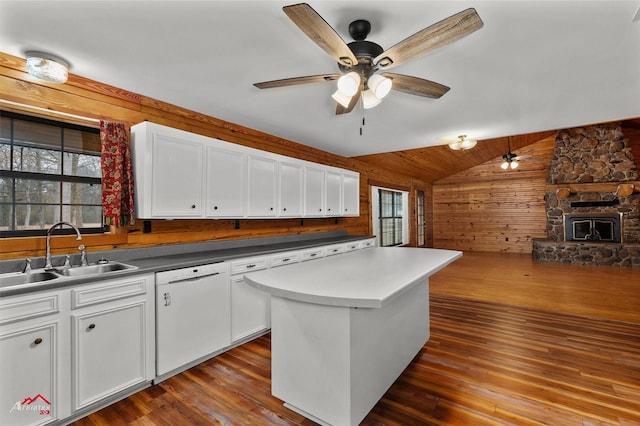 kitchen with white dishwasher, sink, and white cabinets