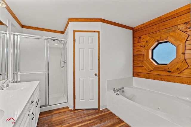 bathroom featuring vanity, wood-type flooring, ornamental molding, and shower with separate bathtub