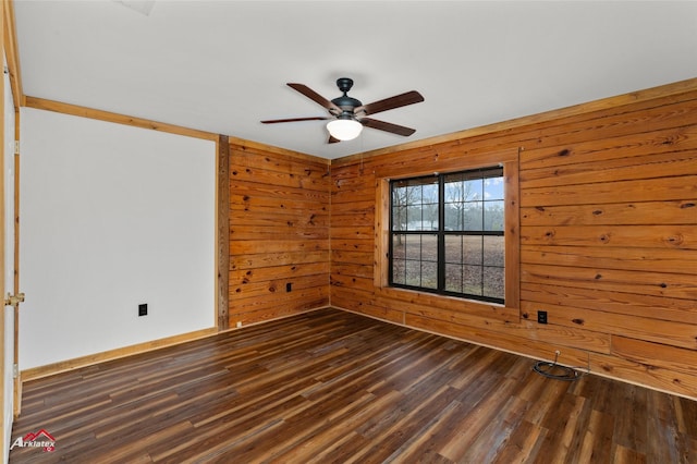 unfurnished room featuring dark wood-type flooring, wooden walls, and ceiling fan