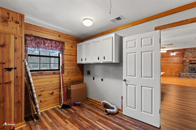 laundry room featuring cabinets, hookup for an electric dryer, hookup for a washing machine, and wood walls