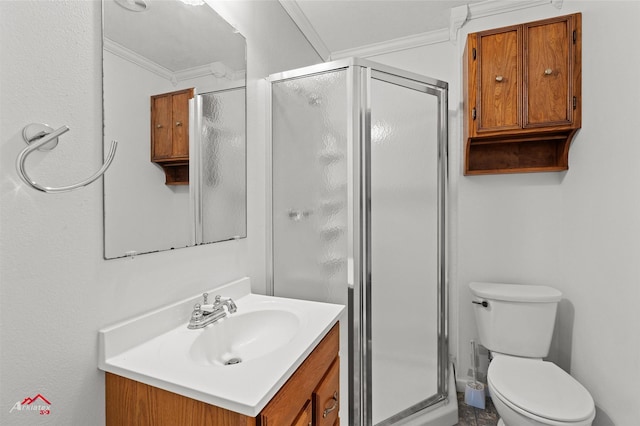 bathroom with ornamental molding, toilet, a shower with door, and vanity