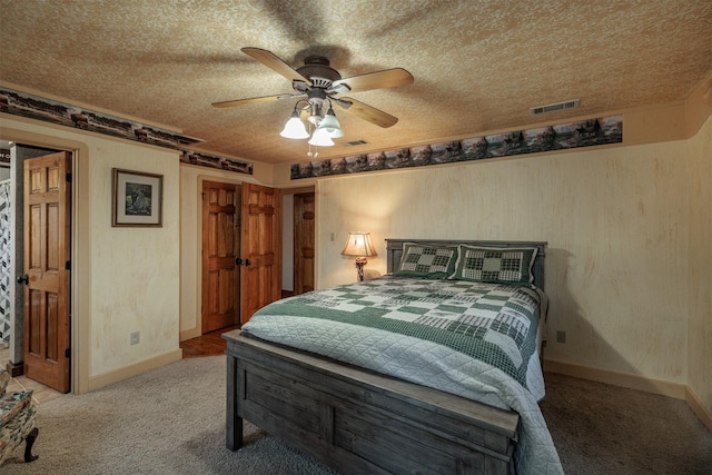 carpeted bedroom with a textured ceiling and ceiling fan