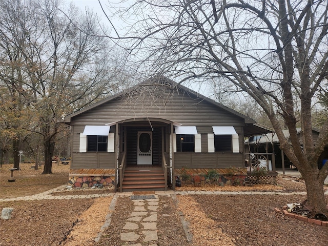 bungalow-style house featuring a carport