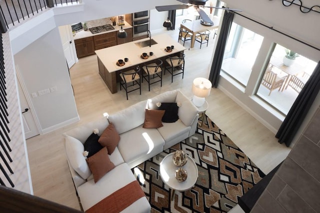 living room featuring ceiling fan and light hardwood / wood-style flooring