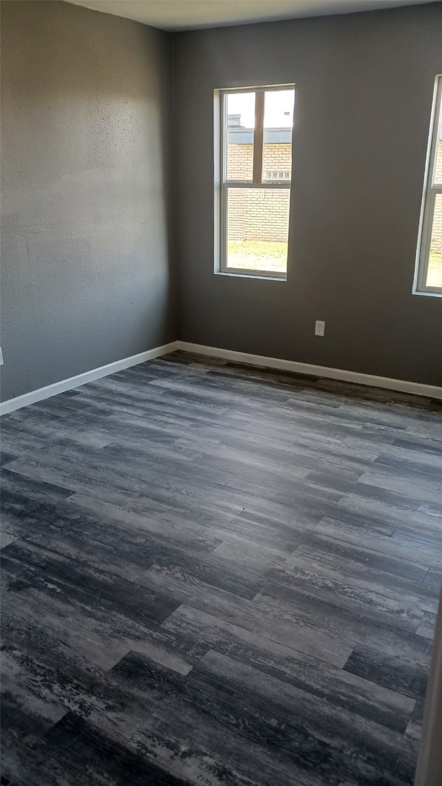 empty room featuring dark hardwood / wood-style floors