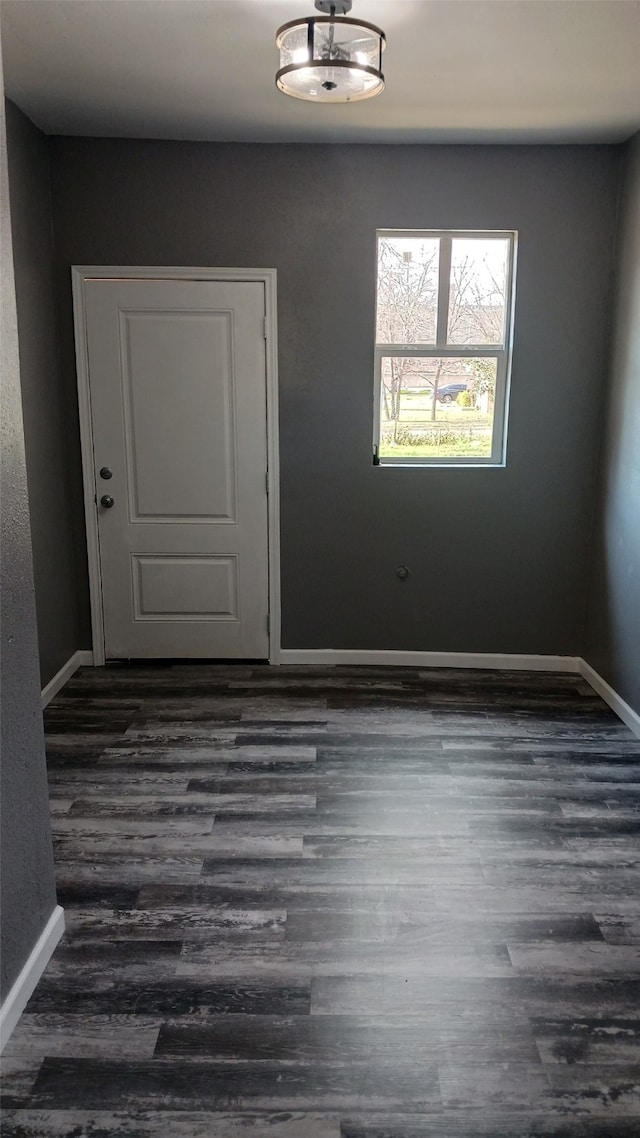 unfurnished room featuring dark hardwood / wood-style flooring