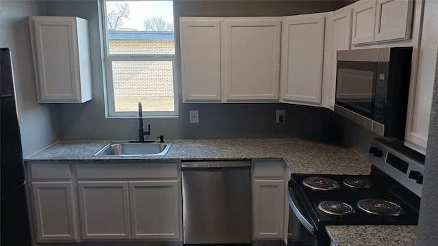 kitchen with white cabinetry, appliances with stainless steel finishes, sink, and a wealth of natural light