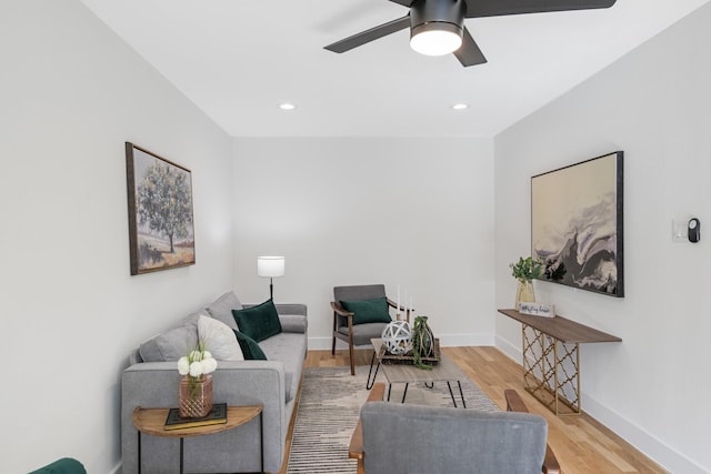 living room with wood finished floors, baseboards, a ceiling fan, and recessed lighting